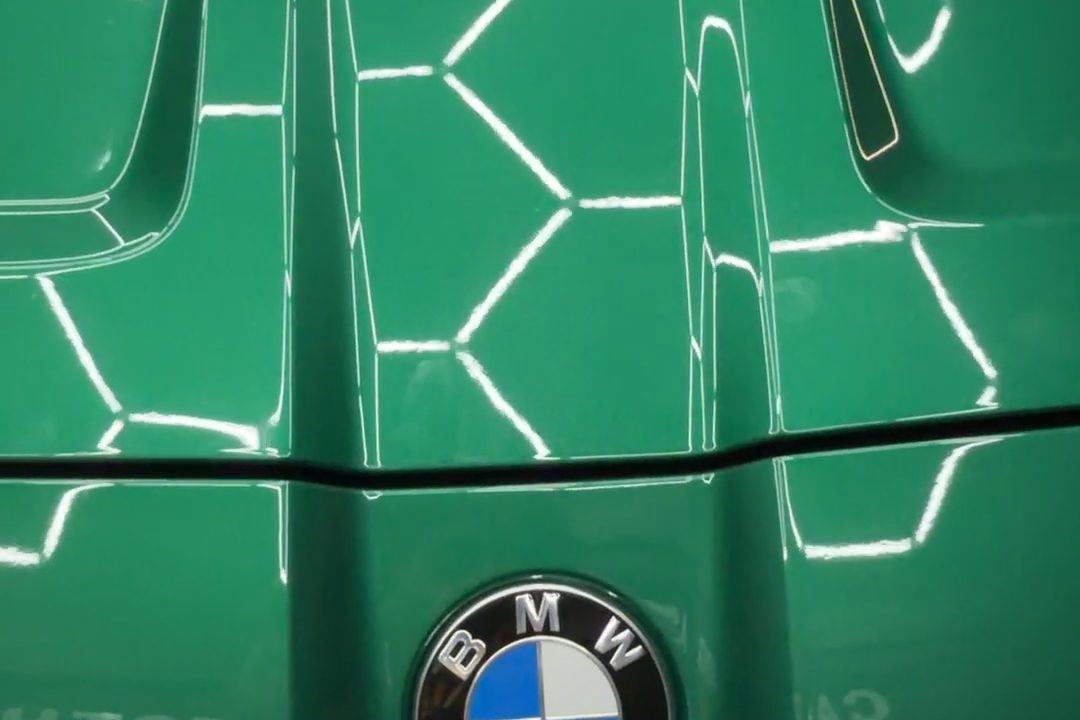 Green BMW M4 hood with a mirror-gloss finish