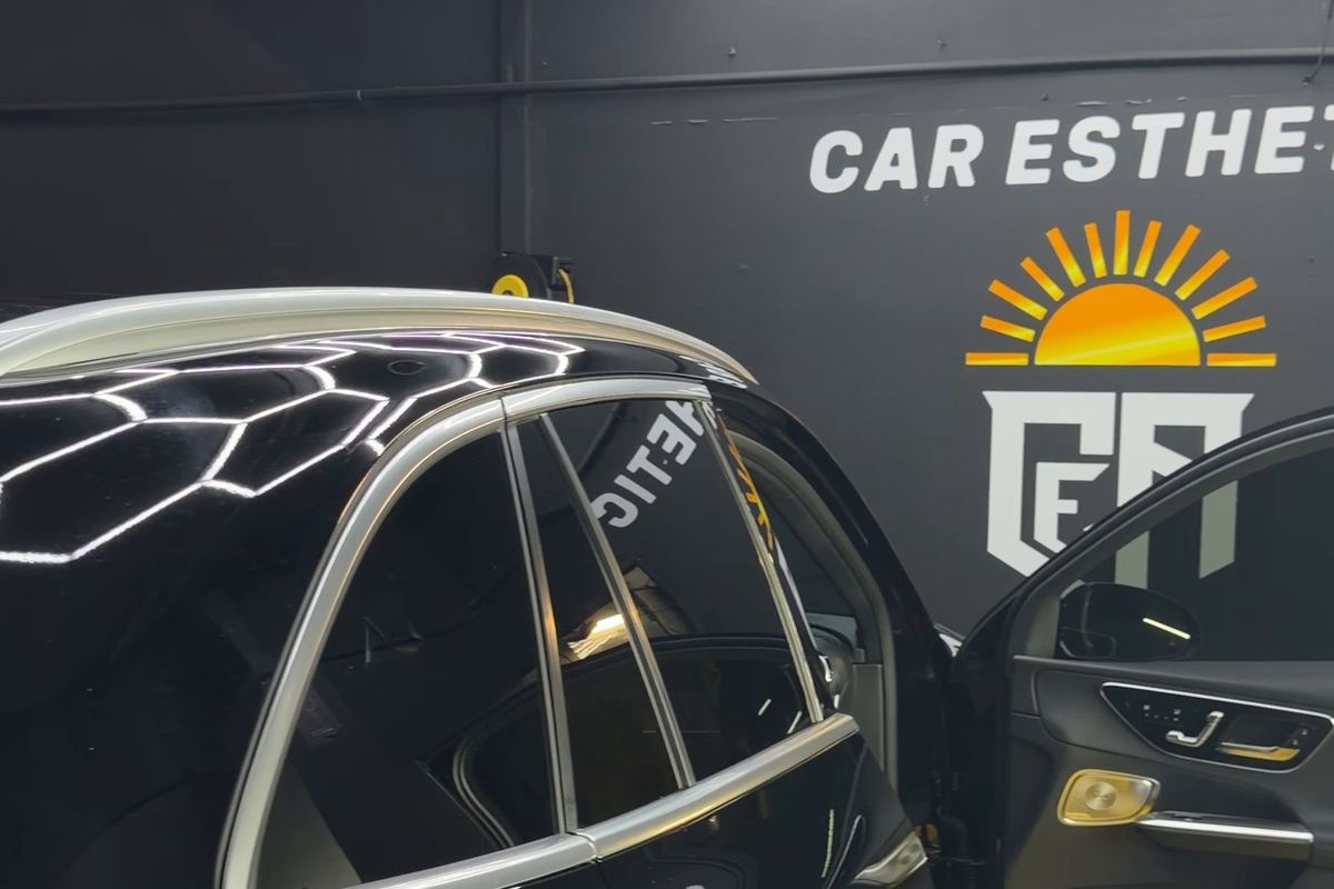 Rear window tint on a black Mercedes SUV in front of the CEA logo wall in Orlando